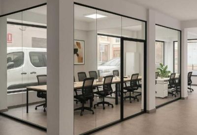 Small private office with window view and potted plants.