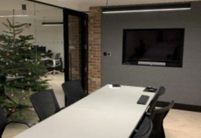 Modern conference room featuring a large screen and a decorated Christmas tree.