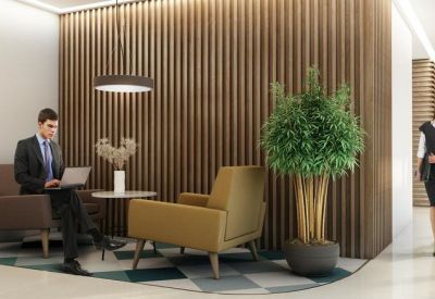 Lounge area featuring a wood-slatted wall and comfortable seating.