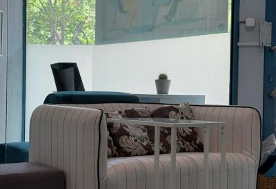 Modern lounge area with a striped armchair and natural light from large windows.