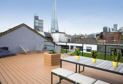 Spacious rooftop terrace at 5-7 Tanner Street, Bermondsey, with wooden decking and views of the Shard.