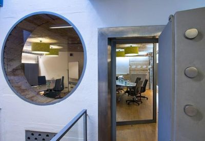 View through a circular internal window into a modern conference room.