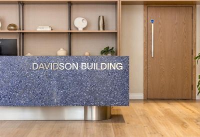 Reception area featuring a blue textured desk with building signage.