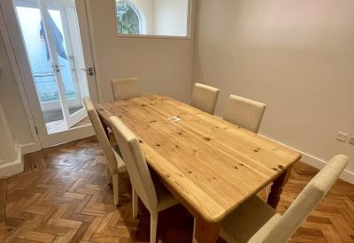 Six-person meeting room with a wooden table and classic parquet flooring.