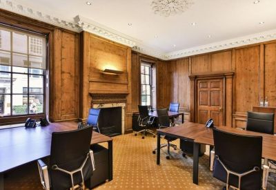 Spacious wood-paneled office with multiple desks and warm natural light.