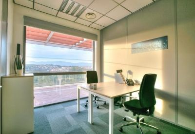 Private windowed office with two desks and view of the hills.