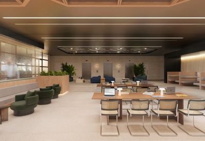 Spacious coworking hub with long wooden tables, woven chairs, and sleek black ceilings.