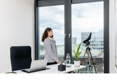 Private office suite with a workspace overlooking the city through large windows.