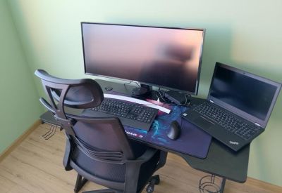 Dual monitor desk setup with ergonomic chair