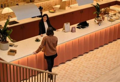 Modern reception desk with a textured terracotta front and marble countertop.