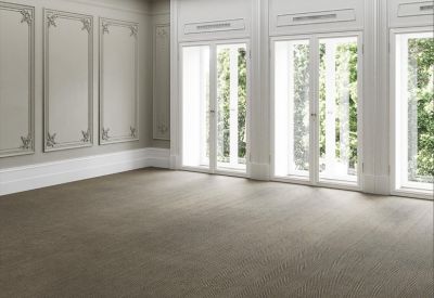 Spacious empty office with classic wall paneling and floor-to-ceiling windows.