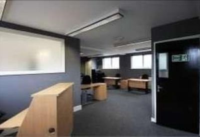 Reception area featuring a wooden front desk and dark accent walls.