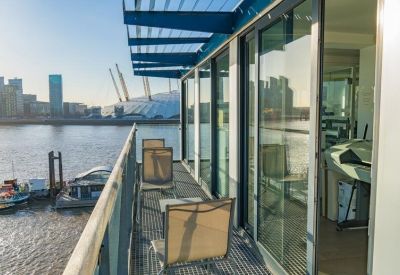 Private balcony with outdoor seating and river views of the O2 Arena.