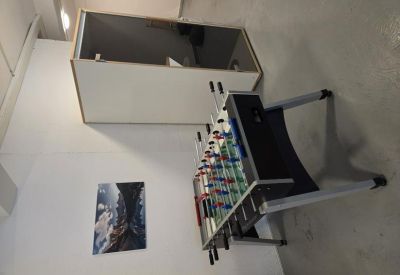 Communal break area featuring a foosball table and a private phone booth.