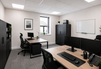Modern office workstation featuring dual monitors and ergonomic chairs.
