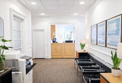 Welcoming reception area with a wooden front desk and comfortable seating.