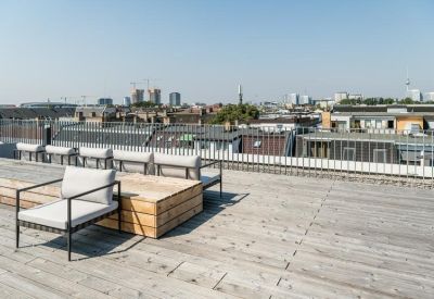 Rooftop terrace with seating and city views.