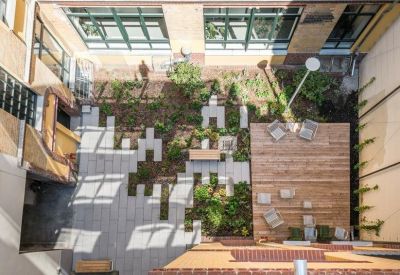 Courtyard with mixed seating and greenery.