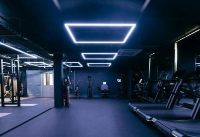 Modern gym with treadmills and dynamic lighting.