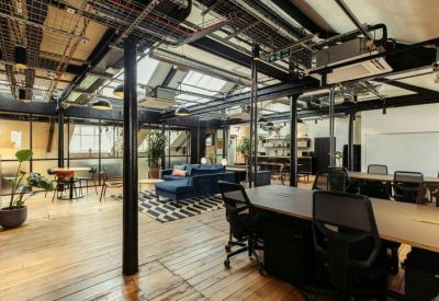 Open-plan workspace with skylights and multiple desks.
