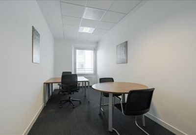 Spacious boardroom featuring a long wooden table and bright window.