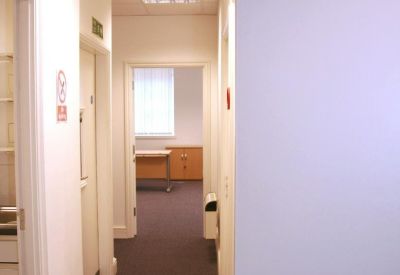 Narrow hallway with carpeting and office doors.