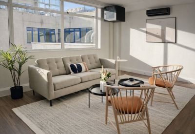 Open-plan workspace with white desks, ergonomic chairs, and plenty of natural light.