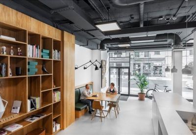 Bright lobby area with a library wall and a small meeting table.