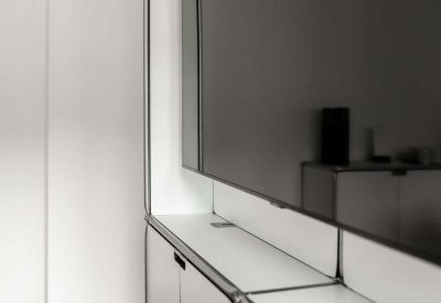 Modern communal storage unit and media wall with a minimalist white finish.