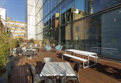 Outdoor roof terrace with wooden decking and various seating arrangements.