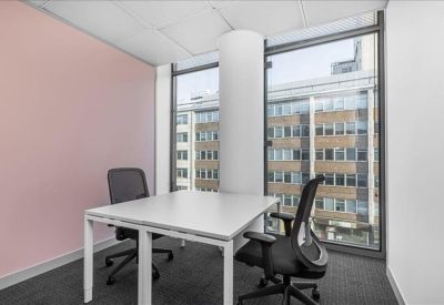 Private office for two featuring a pink accent wall and floor-to-ceiling windows.