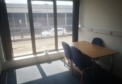 Meeting room with a wooden table and large windows.
