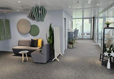 Spacious lounge area with gray sofas, colorful cushions, and green accent decor.