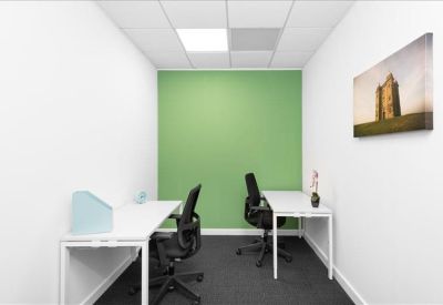Two-person private office suite with a green feature wall.