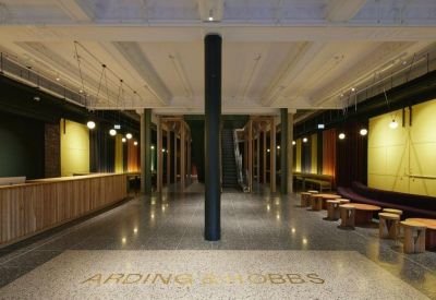 Grand lobby of the Arding & Hobbs building with a marble floor and central black column.