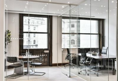 Private office suite separated by glass partitions with city views.