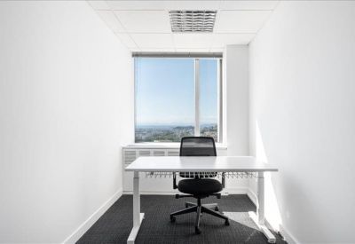 Private one-person office with a white desk and panoramic window views.