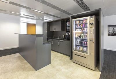 Breakout area featuring a snack vending machine and a modern kitchen unit.