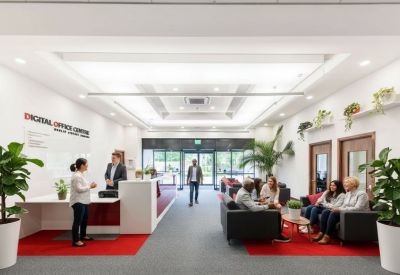 Spacious reception area with white desks, red accents, and large potted plants.