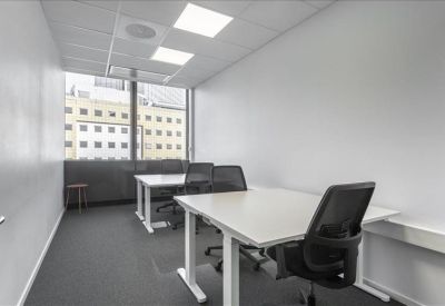 Private internal two-person office suite with minimalist white desks.