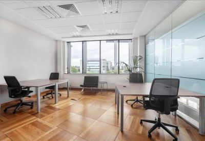 Bright private office suite with wood floors and frosted glass partitions.