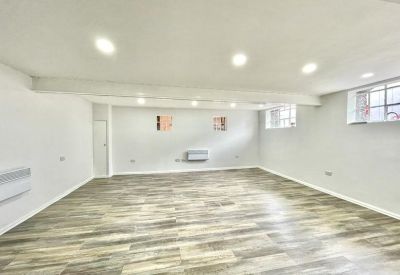 Large open space with wooden floors and bright lighting.