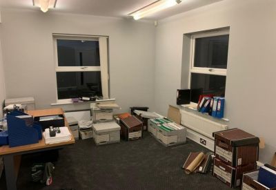 Storage or archive room filled with various filing boxes and office equipment.