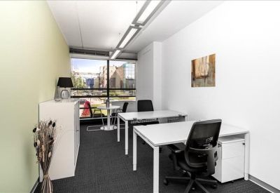 Modern two-person office suite with natural light and a garden view.
