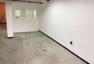 Empty private office room with white walls and a grey carpeted floor.