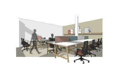 Open-plan office with long wooden desks and black ergonomic chairs.