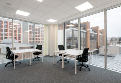 Quiet two-person office suite with large floor-to-ceiling windows and city views.