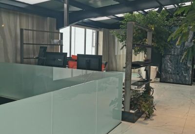 Frosted glass partition separating modern office workstations from the corridor.