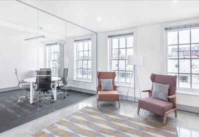 Sleek reception desk with a dark feature wall and a wall-mounted screen.