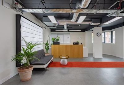 Reception area featuring a wooden front desk and a red floor runner.